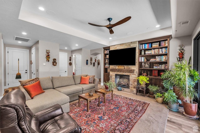 2751 S 3970 W, Hurricane, UT 84737 - living room featuring ceiling fan, wood finished floors, arched walkways, recessed lighting, and a stone fireplace