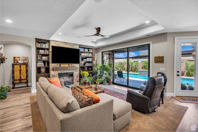 2751 S 3970 W, Hurricane, UT 84737 - living area featuring a stone fireplace, light wood-type flooring, ceiling fan, recessed lighting, and built in features