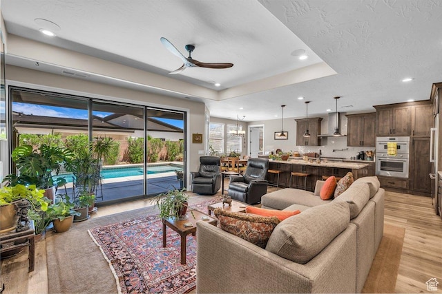 2751 S 3970 W, Hurricane, UT 84737 - living area featuring ceiling fan, light wood finished floors, recessed lighting, a tray ceiling, and a textured ceiling