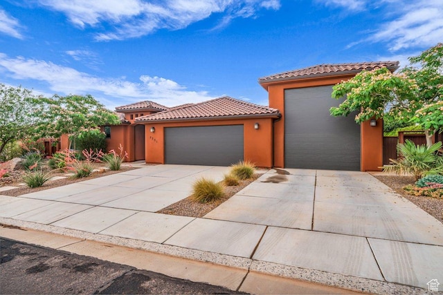 2751 S 3970 W, Hurricane, UT 84737 - mediterranean / spanish house featuring a tile roof, an attached garage, stucco siding, and concrete driveway