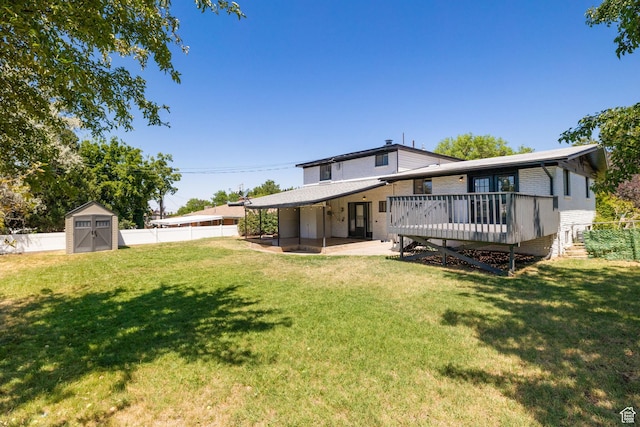 2111 W 5800 S, Roy, UT 84067 - back of property featuring a deck, a storage unit, a fenced backyard, brick siding, and a patio