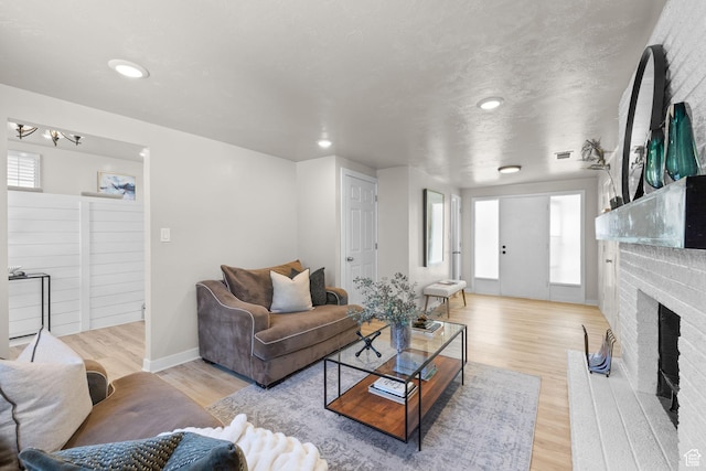 2111 W 5800 S, Roy, UT 84067 - living room with a brick fireplace, light wood-style floors, recessed lighting, and a chandelier