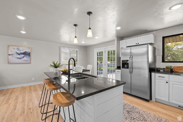 2111 W 5800 S, Roy, UT 84067 - kitchen featuring stainless steel refrigerator with ice dispenser, plenty of natural light, white cabinets, light wood-type flooring, and recessed lighting