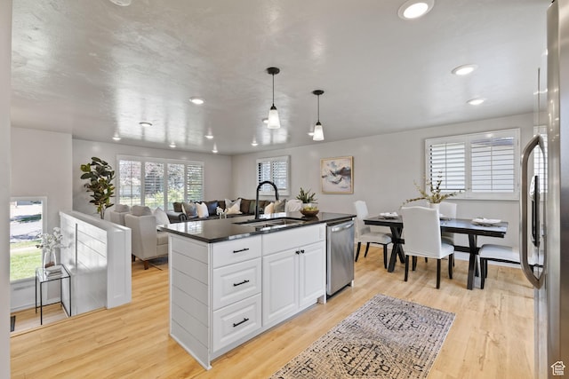 2111 W 5800 S, Roy, UT 84067 - kitchen with appliances with stainless steel finishes, dark countertops, white cabinets, recessed lighting, and light wood-type flooring
