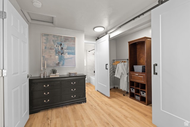 2111 W 5800 S, Roy, UT 84067 - bedroom featuring a barn door, light wood-style floors, attic access, and ensuite bath