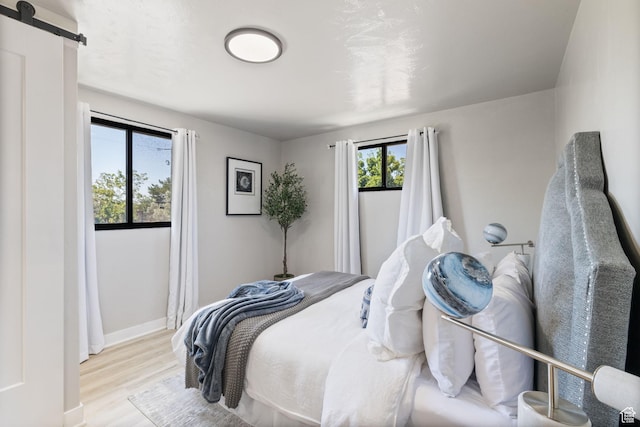 2111 W 5800 S, Roy, UT 84067 - bedroom with a barn door and wood finished floors