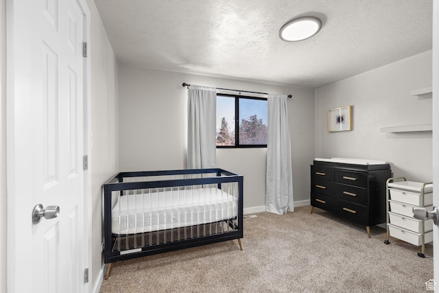 2111 W 5800 S, Roy, UT 84067 - bedroom featuring a textured ceiling, light carpet, and a nursery area