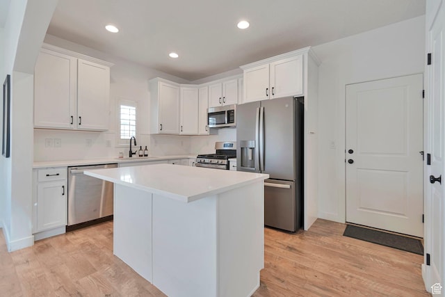 6427 W Arranmore Dr, South Jordan, UT 84009 - kitchen with stainless steel appliances, light wood-type flooring, white cabinets, light countertops, and recessed lighting