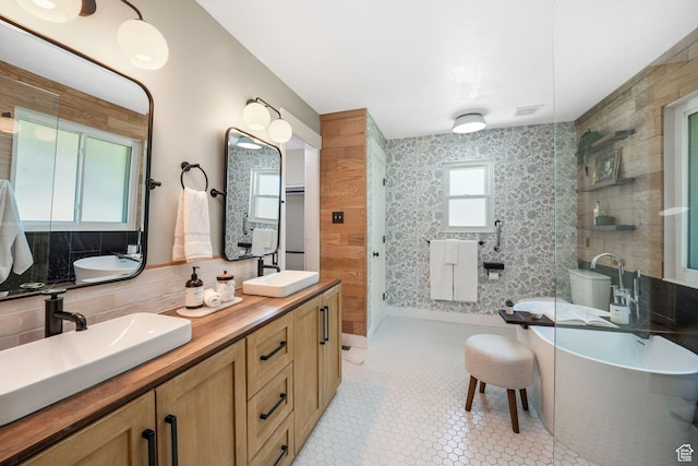 2038 W 8970 S, West Jordan, UT 84088 - bathroom with double vanity, a soaking tub, an enclosed shower, backsplash, and tile patterned floors
