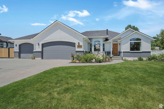 2038 W 8970 S, West Jordan, UT 84088 - ranch-style house with a garage, a front lawn, brick siding, driveway, and stucco siding