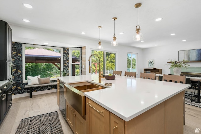 2038 W 8970 S, West Jordan, UT 84088 - kitchen with light countertops, recessed lighting, a kitchen island with sink, hanging light fixtures, and light wood-style floors