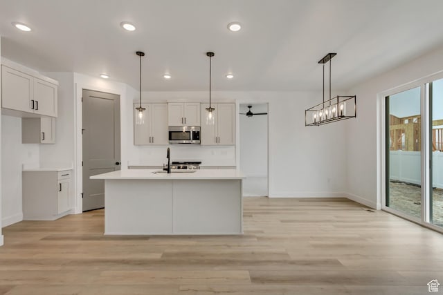 1274 N 1475 E Unit 37, Payson, UT 84651 - kitchen with stainless steel microwave, light wood-style flooring, ceiling fan, light countertops, and recessed lighting
