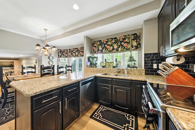 11803 Burkwood Ln, Draper, UT 84020 - kitchen featuring stainless steel appliances, crown molding, decorative backsplash, a chandelier, and dark cabinets