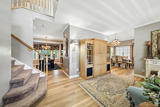 11803 Burkwood Ln, Draper, UT 84020 - living room featuring a chandelier, crown molding, stairs, and light wood-style floors
