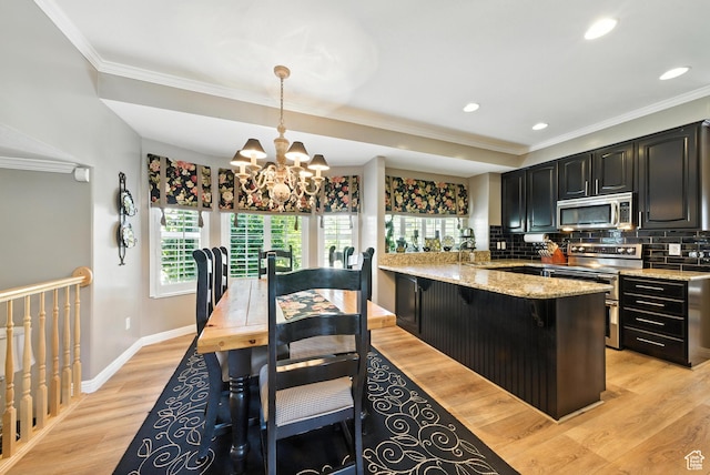 11803 Burkwood Ln, Draper, UT 84020 - kitchen featuring appliances with stainless steel finishes, a chandelier, crown molding, backsplash, and dark cabinetry