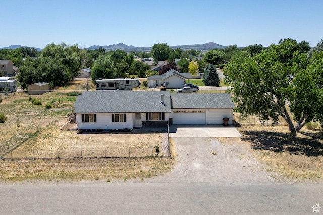 5317 N 2700 W, Cedar City, UT 84721 - ranch-style house with an attached garage, dirt driveway, and a mountain view