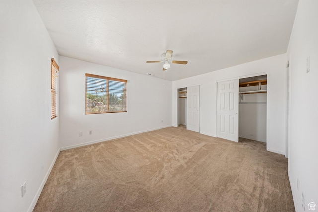 5317 N 2700 W, Cedar City, UT 84721 - unfurnished bedroom featuring multiple closets, light carpet, and a ceiling fan