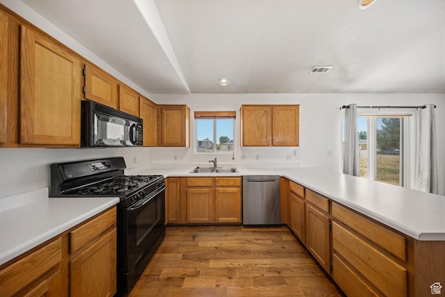 5317 N 2700 W, Cedar City, UT 84721 - kitchen with black appliances, a peninsula, healthy amount of natural light, wood finished floors, and recessed lighting