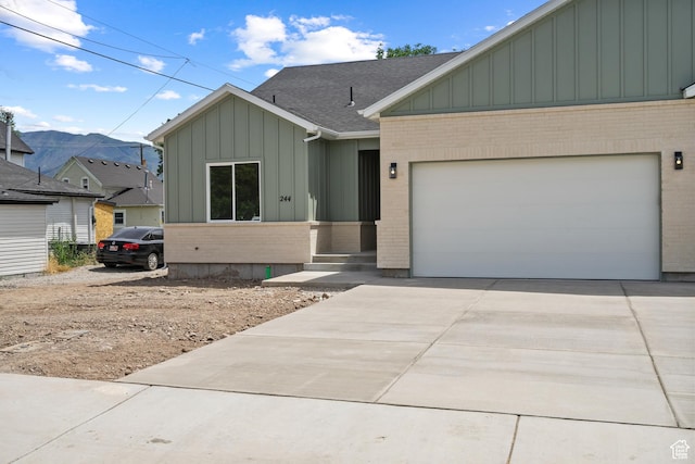 244 E 300 N, Payson, UT 84651 - view of front of home with board and batten siding, brick siding, concrete driveway, and an attached garage