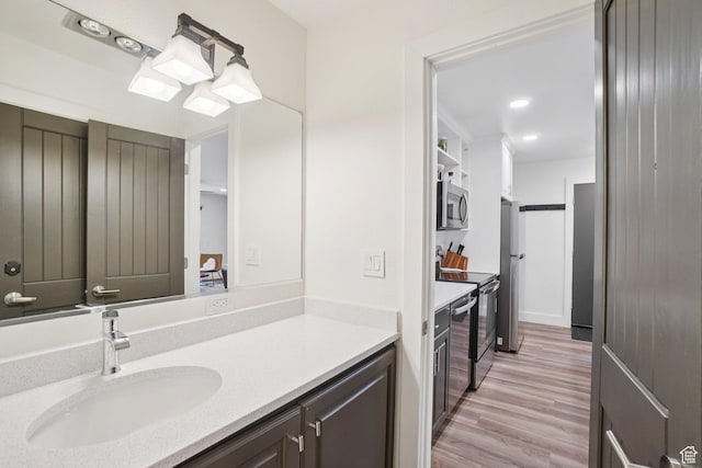 2025 Canyons Resort Dr Unit I1, Park City, UT 84098 - bathroom featuring wood finished floors, vanity, and recessed lighting