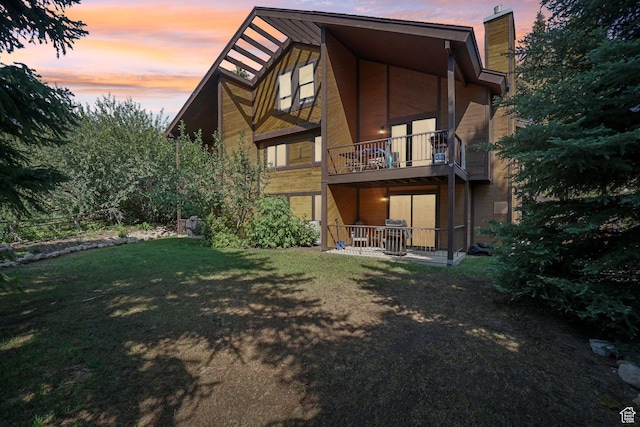 2025 Canyons Resort Dr Unit I1, Park City, UT 84098 - back of property featuring a balcony, a chimney, and a lawn