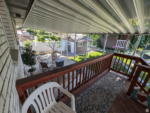 1704 S Sorrento Dr, Woods Cross, UT 84087 - deck featuring a storage unit, a patio, and a fenced backyard