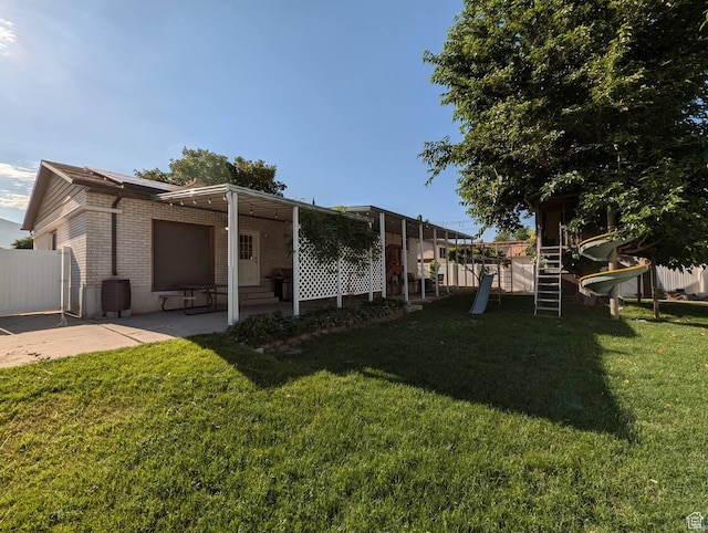 1704 S Sorrento Dr, Woods Cross, UT 84087 - rear view of property featuring brick siding, a patio, and entry steps