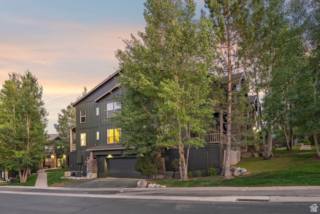 1729 Fox Bay Dr Unit J104, Heber City, UT 84032 - view of front of property with an attached garage, board and batten siding, asphalt driveway, and a yard
