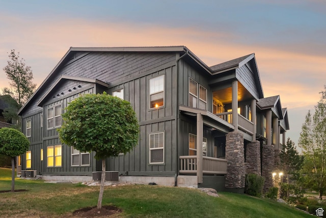 1729 Fox Bay Dr Unit J104, Heber City, UT 84032 - property exterior at dusk with board and batten siding, a balcony, and a lawn