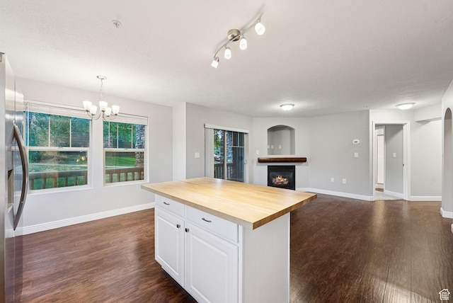 1729 Fox Bay Dr Unit J104, Heber City, UT 84032 - kitchen featuring wood counters, dark wood-style flooring, stainless steel fridge, and a lit fireplace