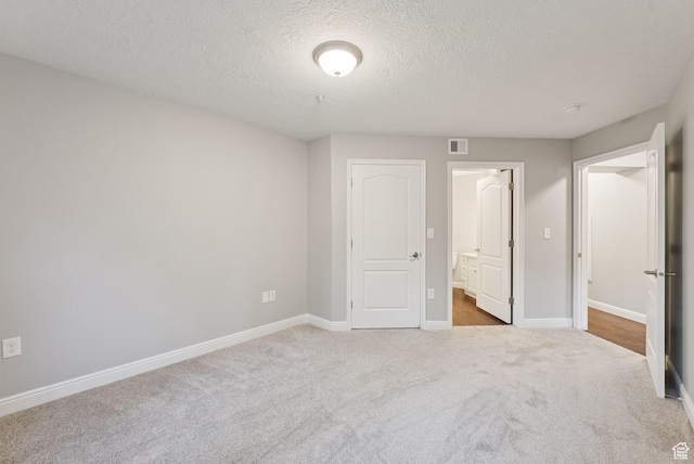 1729 Fox Bay Dr Unit J104, Heber City, UT 84032 - unfurnished bedroom with a textured ceiling, carpet floors, and ensuite bath