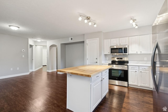 1729 Fox Bay Dr Unit J104, Heber City, UT 84032 - kitchen with appliances with stainless steel finishes, butcher block counters, a kitchen island, dark wood finished floors, and white cabinets
