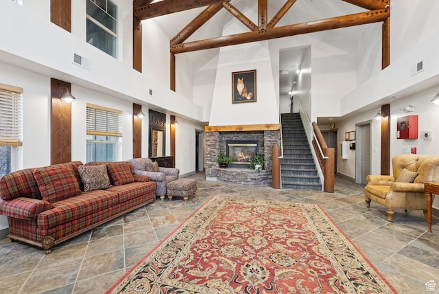 1729 Fox Bay Dr Unit J104, Heber City, UT 84032 - living area featuring high vaulted ceiling, stone tile flooring, stairway, and a stone fireplace