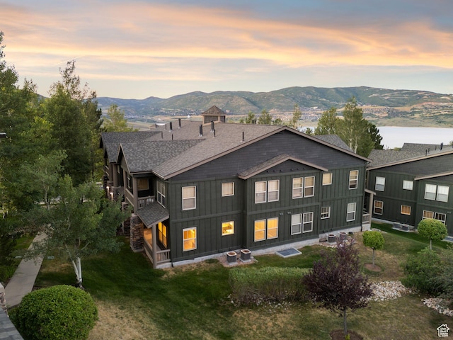 1729 Fox Bay Dr Unit J104, Heber City, UT 84032 - back of house at dusk with roof with shingles, board and batten siding, a mountain view, and a yard