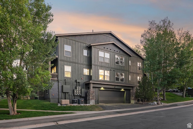 1729 Fox Bay Dr Unit J104, Heber City, UT 84032 - view of front of house with an attached garage, asphalt driveway, board and batten siding, and a front yard