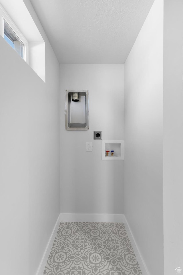 482 N Brook Ave E, Tooele, UT 84074 - laundry room featuring hookup for an electric dryer, hookup for a washing machine, and a textured ceiling