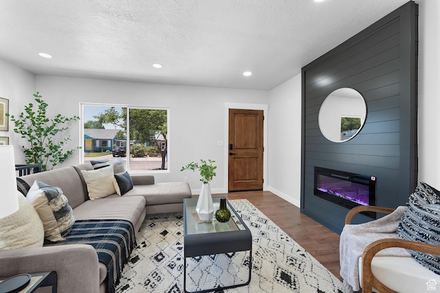 482 N Brook Ave E, Tooele, UT 84074 - living area featuring dark wood-type flooring, recessed lighting, a large fireplace, and a textured ceiling