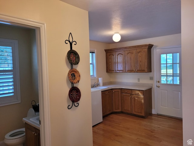 1360 Lakeview Dr, Bountiful, UT 84010 - kitchen with light countertops, light wood-type flooring, and brown cabinets