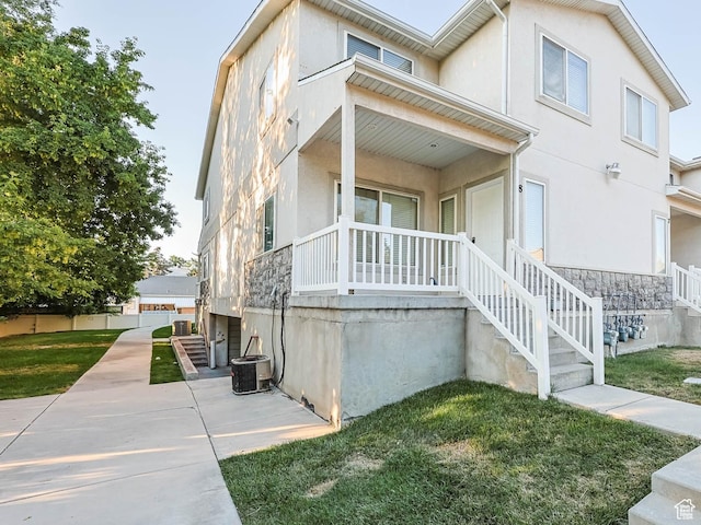4072 S 300 E Unit 8, Salt Lake City, UT 84107 - view of front of house with covered porch, stucco siding, a front lawn, and stone siding