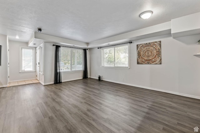 4072 S 300 E Unit 8, Salt Lake City, UT 84107 - unfurnished living room featuring wood finished floors and a textured ceiling