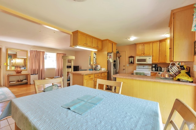 4790 Burch Dr, South Ogden, UT 84403 - kitchen featuring white appliances, a peninsula, light brown cabinets, and light countertops