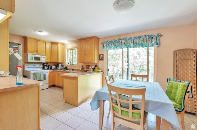 4790 Burch Dr, South Ogden, UT 84403 - kitchen with white appliances, light brown cabinets, a peninsula, light tile patterned floors, and a heating unit