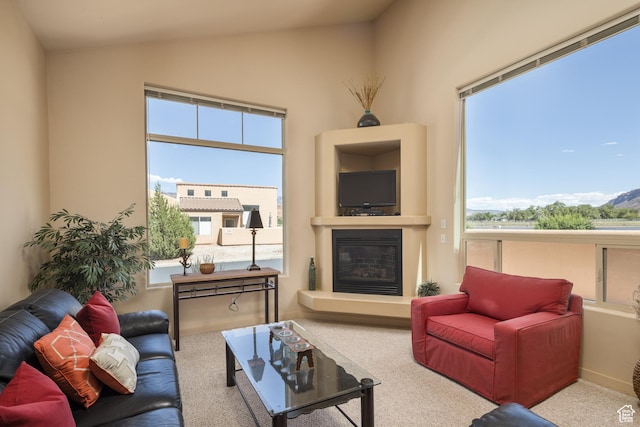 3686 S Spanish Valley Dr Unit N-2, Moab, UT 84532 - carpeted living area with vaulted ceiling, a glass covered fireplace, and plenty of natural light