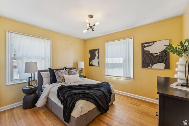 2353 E Logan Cir, Salt Lake City, UT 84108 - bedroom with a chandelier and light wood-style flooring