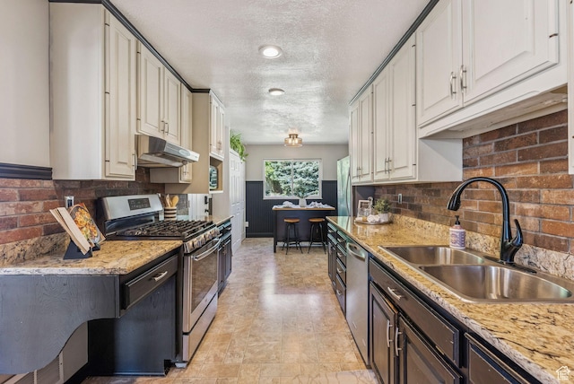2353 E Logan Cir, Salt Lake City, UT 84108 - kitchen with appliances with stainless steel finishes, under cabinet range hood, a textured ceiling, backsplash, and light stone counters