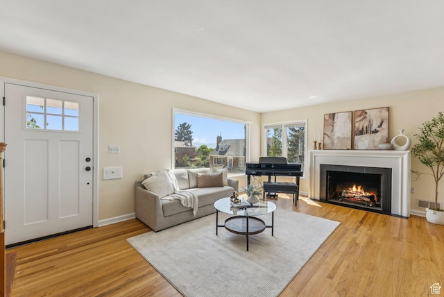 2353 E Logan Cir, Salt Lake City, UT 84108 - living area with healthy amount of natural light, light wood finished floors, and a fireplace with flush hearth