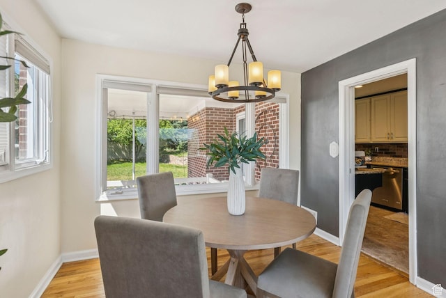 2353 E Logan Cir, Salt Lake City, UT 84108 - dining room with a chandelier and light wood-style flooring