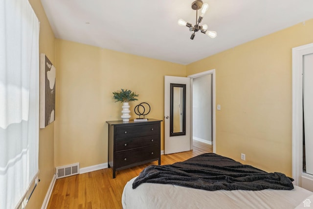 2353 E Logan Cir, Salt Lake City, UT 84108 - bedroom featuring light wood-style flooring and a chandelier