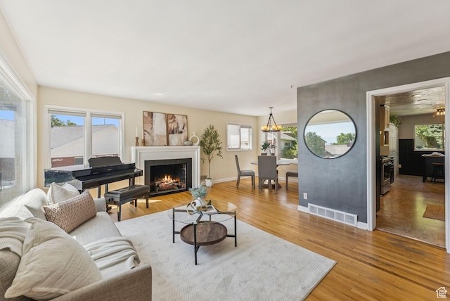 2353 E Logan Cir, Salt Lake City, UT 84108 - living area with plenty of natural light, light wood finished floors, and a warm lit fireplace