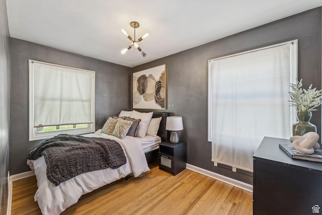 2353 E Logan Cir, Salt Lake City, UT 84108 - bedroom featuring a chandelier and light wood finished floors